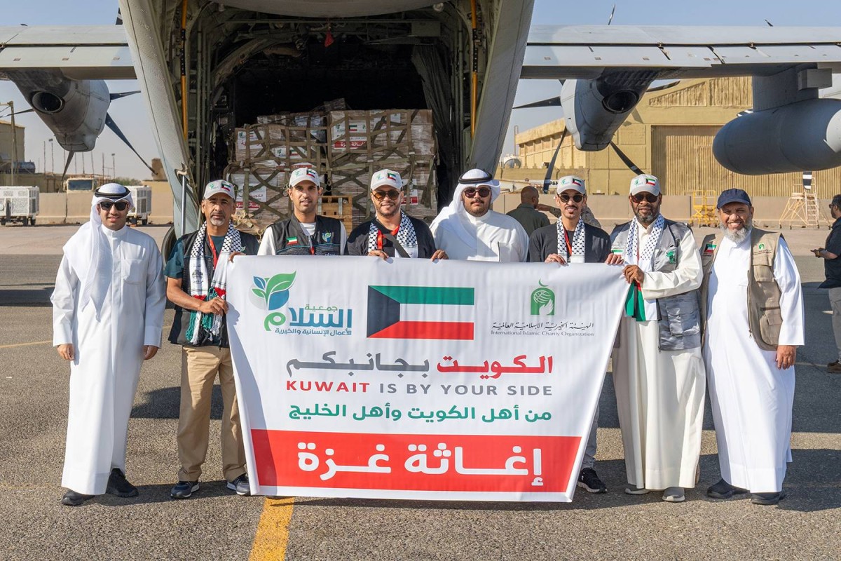 KUWAIT: Officials of Charity societies in charge of collecting and preparing aid pose for a group photo.-- KUNA