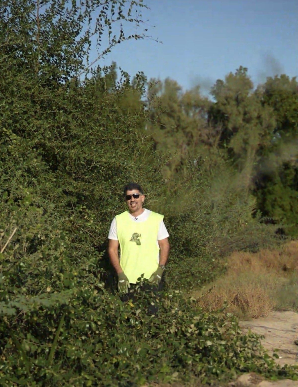 Dr Issa Al-Issa standing in the middle of the forest.