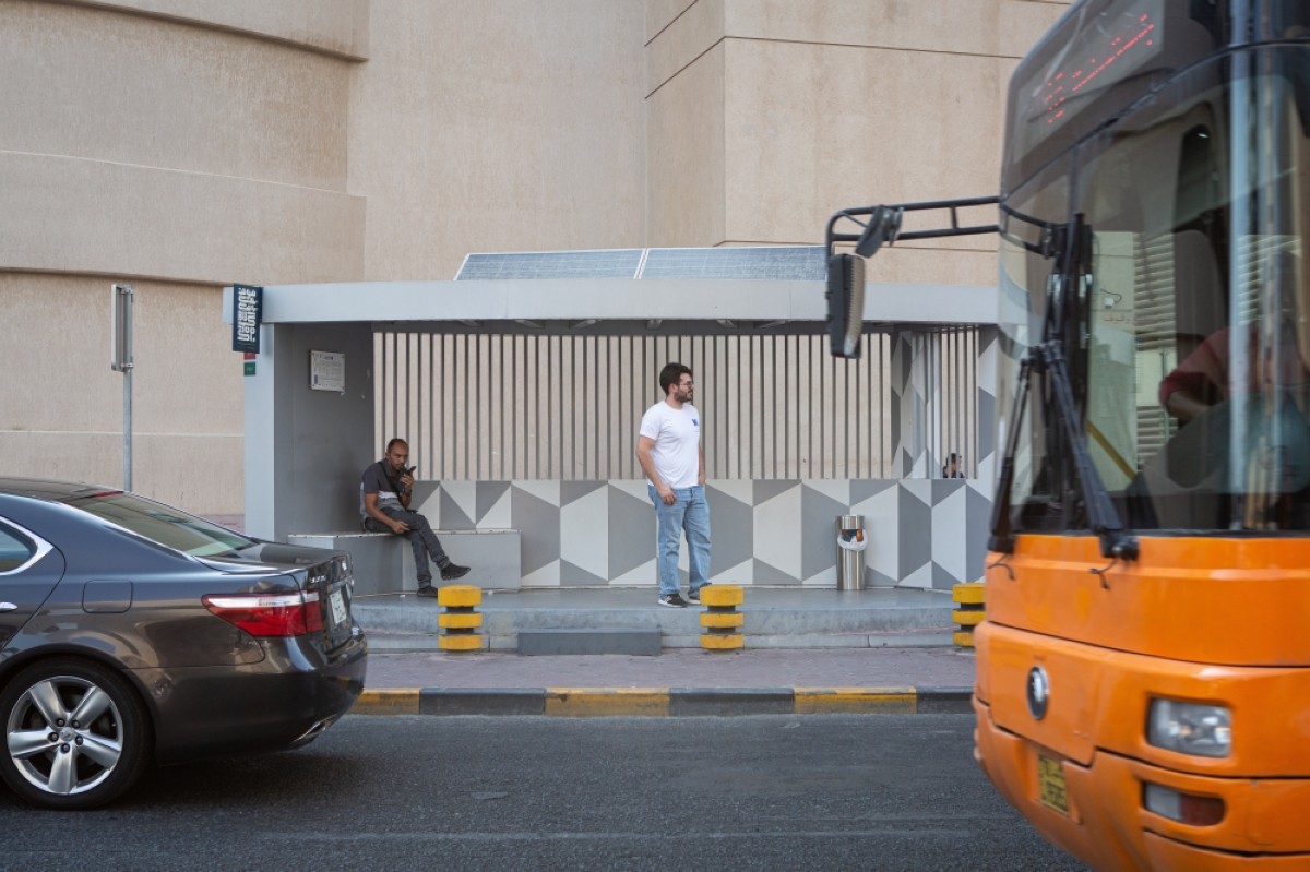 KUWAIT CITY: Jassim Al-Awadhi waits at a bus stop as a bus approaches in this file photo. 