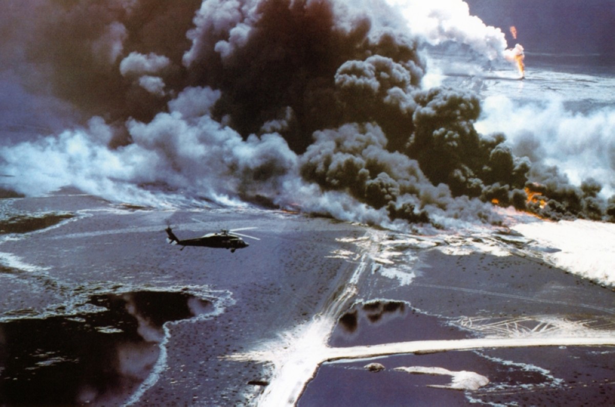 A helicopter flied over burning oil fields which were set on fire by Iraqi soldiers before they retreated from Kuwait. 