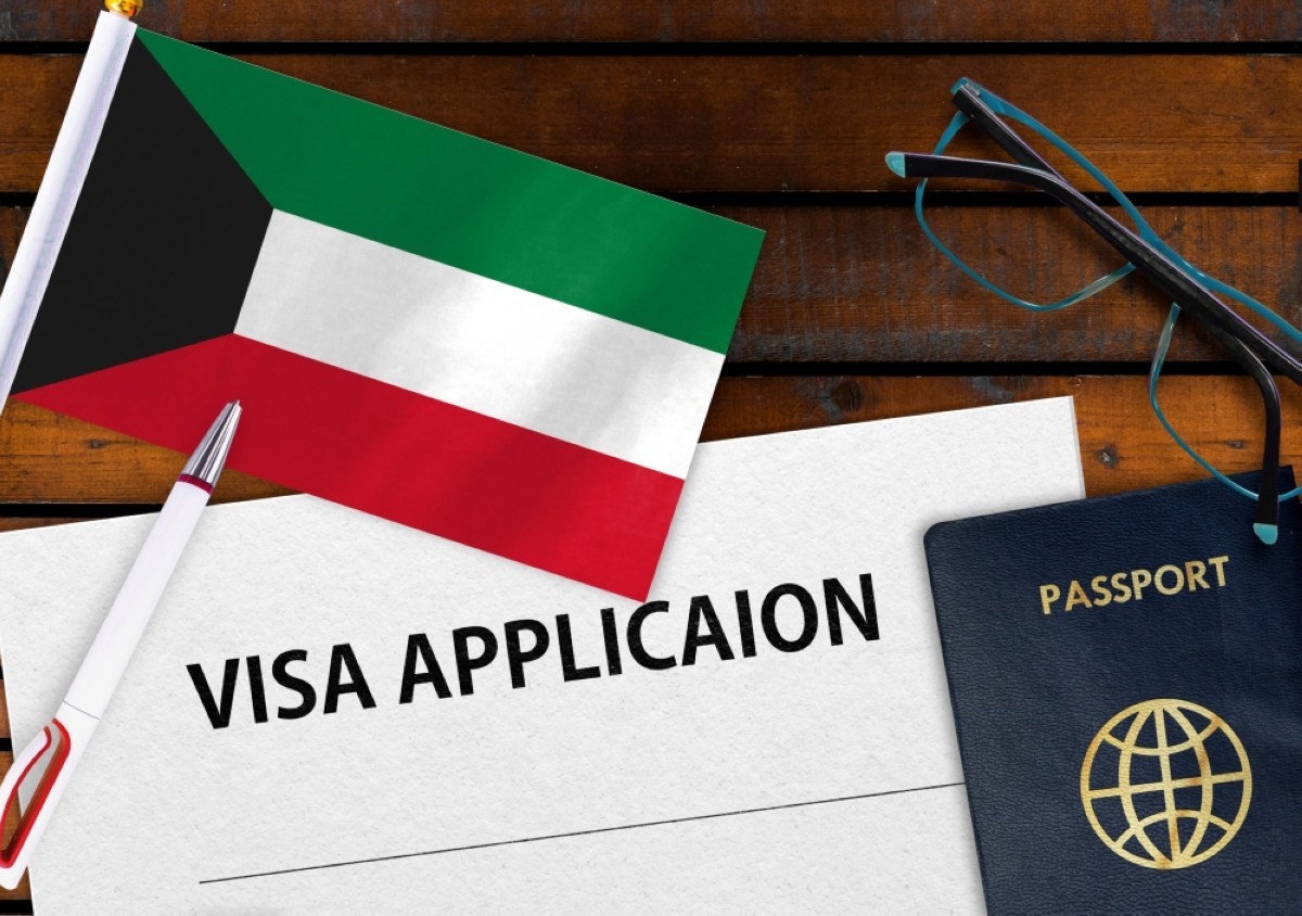 Flag of Kuwait, visa application form and passport on table