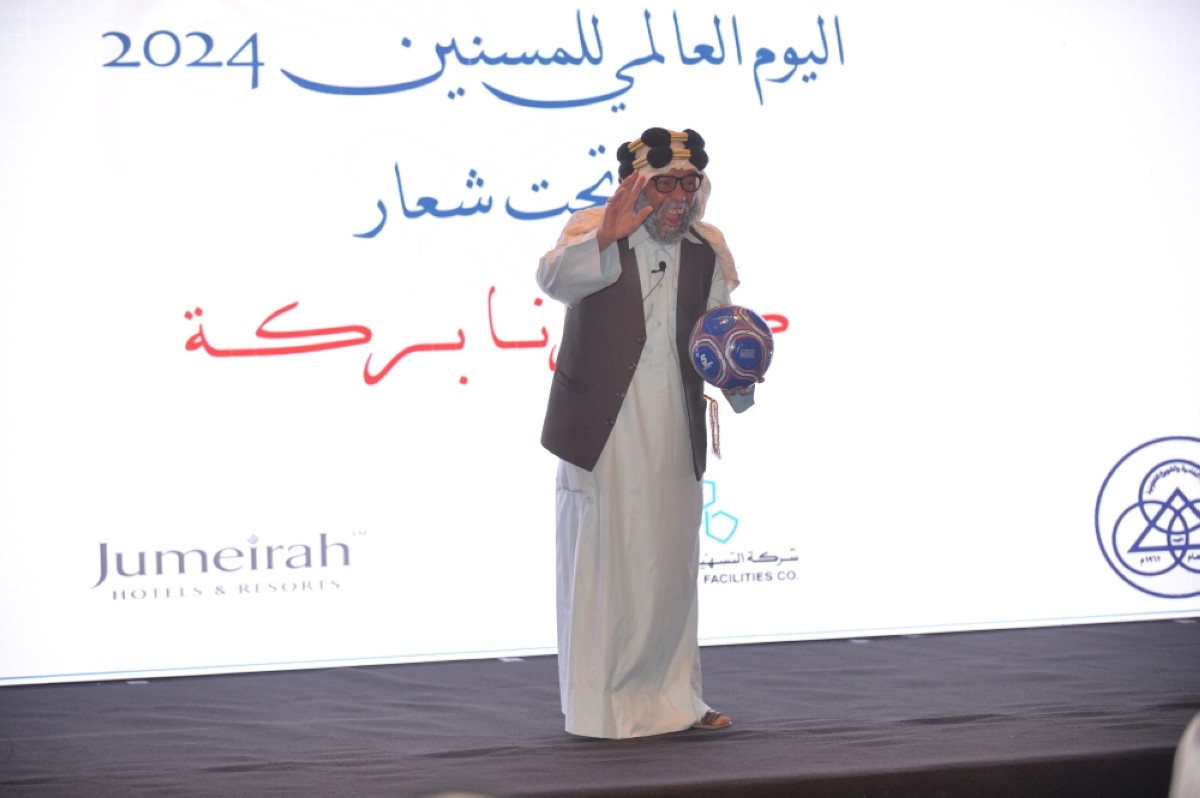 An elderly man entertains attendees during a performance at the event. 