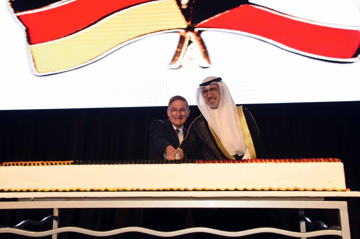 Minister of Commerce Khalifa Abdullah al Askar and the German ambassador cut a celebratory cake as Germany marks the 34th Day of German Unity. 