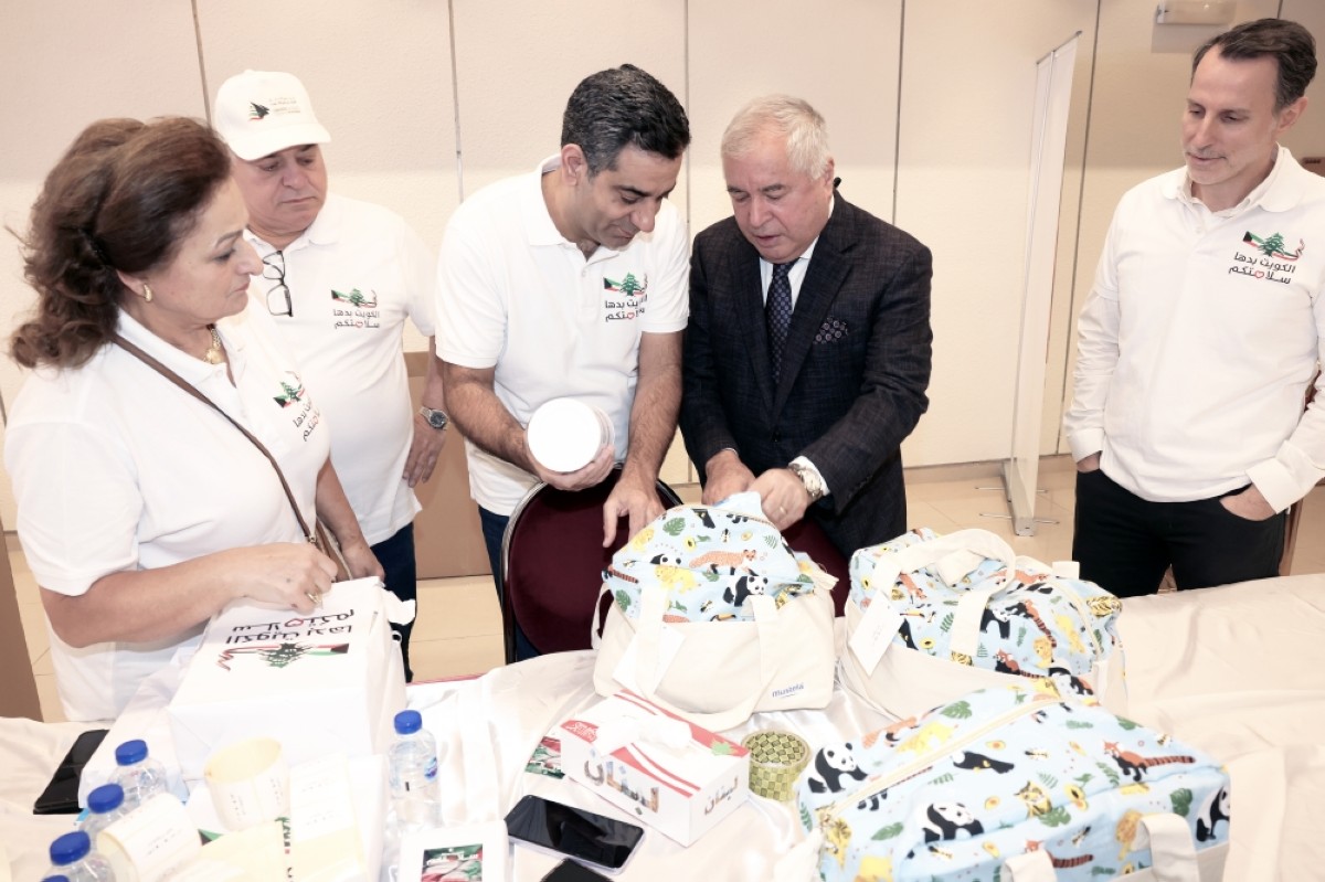 Ahmad Arafa examines donated goods with Dean of the Diplomatic Corps Zubaydullo Zubaydov. 