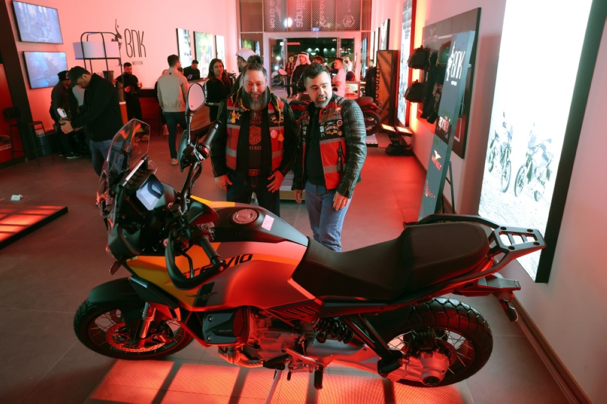 
Bikers examine a motorcycle on display at the grand opening of BNK Motion Motoplex. 