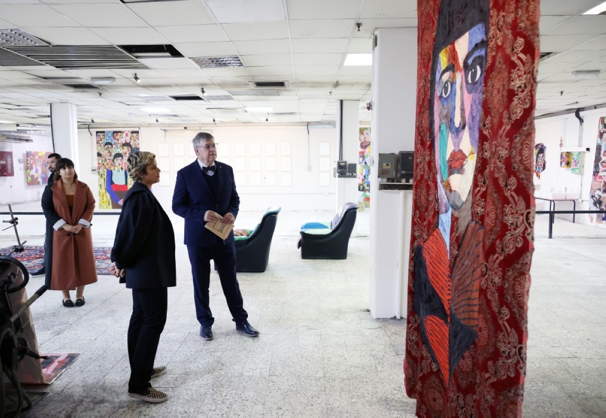 Ambassador of the Czech Republic Juraj Chmiel admires Ghada Al-Kandari&#039;s painting that was displayed at the warehouse.