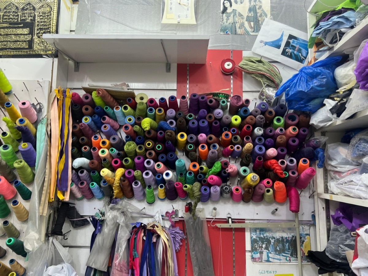 A colourful collection of threads and zippers in Raju&#039;s tailoring shop in the old souq of Salmiya.