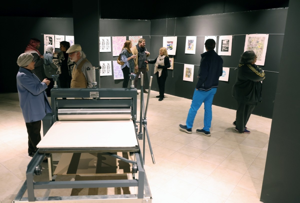 Visitors browse the exhibition where participants from around the world showcased their creative printmaking skills. A printer was also on display to provide a glimpse into how the art work was created. 