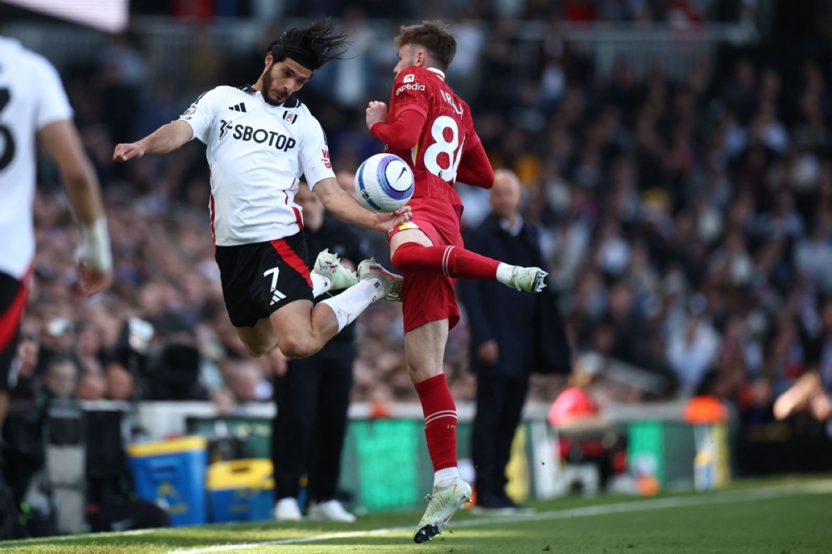 Fulham&#039;s Mexican striker Raul Jimenez vies with Liverpool&#039;s Northern Irish defender Conor Bradley at Craven Cottage in London on April 6, 2025. - AFP photos