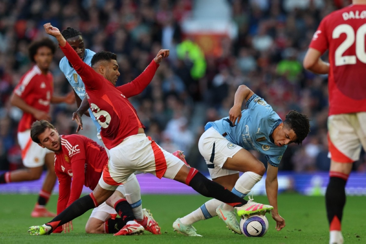 Manchester United&#039;s Brazilian midfielder Casemiro vies with Manchester City&#039;s English defender Rico Lewis at Old Trafford in Manchester on April 6, 2025.