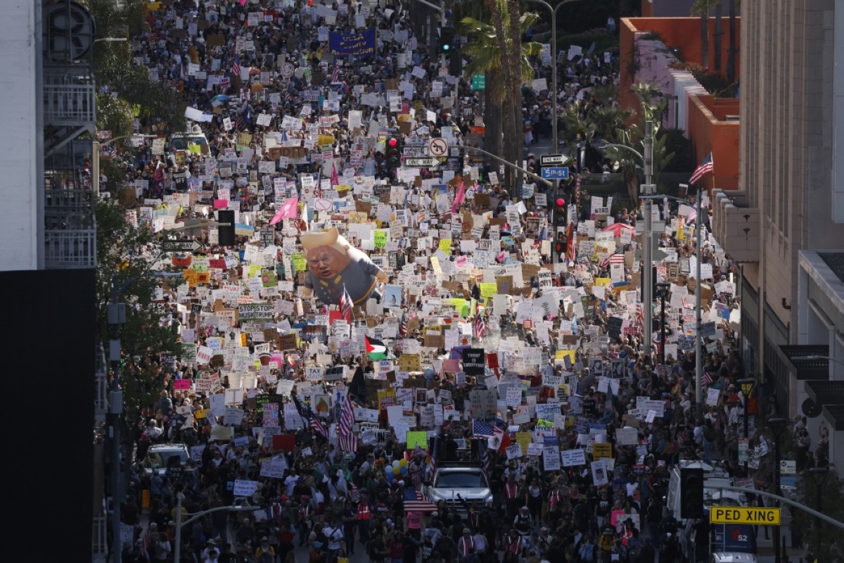 LOS ANGELES: Protesters hold signs and flags and a large balloon with an image of US President Donald Trump during the nationwide "Hands Off!" protest against Trump and his advisor, Tesla CEO Elon Musk, in downtown Los Angeles on April 5, 2025.  — AFP photos 