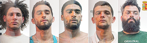 This combination of pictures made on August 7, 2015 of handout pictures taken and released by Italian Police in Palermo on August 7, 2015 shows (L-R) Suud Mujassabi, Imad Busadia, Shauki Esshaush, Ali Rouibah and Abdullah Assnusi, arrested on suspicion of people trafficking and survivors of an August 5 shipwreck carrying over 600 migrants which left more than 200 people feared drowned in the Mediterranean Sea, off the Libyan coast. Three Libyans and two Algerians were arrested on August 7 accused of multiple homicide and human trafficking in connection with the presumed death by drowning of more than 200 migrants after a ship capsized in the Mediterranean. AFP PHOTO / POLIZIA DI STATO -- RESTRICTED TO EDITORIAL USE - MANDATORY CREDIT 