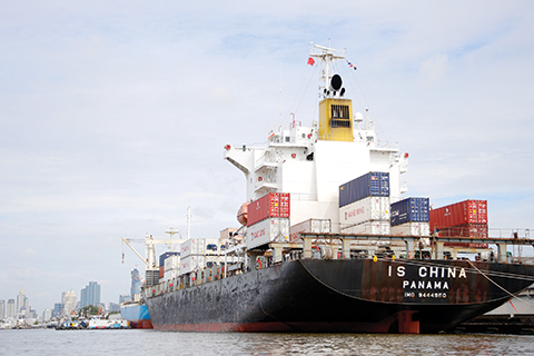 In this Thursday, Aug. 6, 2015, photo, a cargo ship is parked near Klong Toey Port in Bangkok, Thailand.  The Association of Southeast Asian Nations, which on Saturday marks 48 years since its establishment, aims to establish an economic community known as the AEC by the end of this year. Proponents say the ultimate goal is to allow free trade, investment and movement of workers between the 10 nations that make up the grouping. But progress toward a borderless economy in a region that brings together democracies and dictatorships along with rich and poor nations is likely to be slow. (AP Photo/Penny Yi Wang)