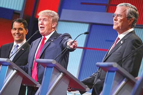 CLEVELAND, OH - AUGUST 06: Republican presidential candidates (L-R) Wisconsin Gov. Scott Walker, Donald Trump and Jeb Bush participate in the first prime-time presidential debate hosted by FOX News and Facebook at the Quicken Loans Arena August 6, 2015 in Cleveland, Ohio. The top-ten GOP candidates were selected to participate in the debate based on their rank in an average of the five most recent national political polls.   Chip Somodevilla/Getty Images/AFPn== FOR NEWSPAPERS, INTERNET, TELCOS &amp; TELEVISION USE ONLY ==