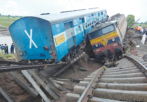 TOPSHOTSnTwo Indian passenger trains lay next to each other following a derailment after they were hit by flash floods on a bridge outside the town of Harda in Madhya Pradesh state on August 5, 2015. Two passenger trains derailed after being hit by flash floods on a bridge in central India, killing at least 27 people in the latest deadly accident on the nation's crumbling rail network. AFP PHOTO