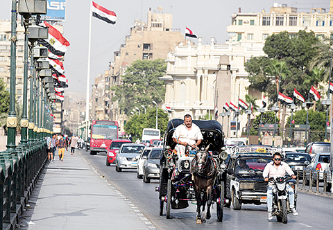 A general view shows different forms of transport on a road in Cairo, on August 10, 2015 as soaring temperatures and humidity hit the Egyptian capital and other parts of the country. Twenty-one people have died and 66 others were hospitalised with exhaustion due to the rise in temperature. AFP PHOTO / MOHAMED EL-SHAHED