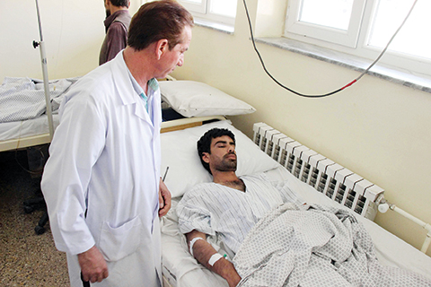 A wounded Afghan receives treatment at a hospital in Kunduz province on August 9, 2015, after a Taliban attack in the northern Afghan city.   A Taliban attack has killed at least 21 people in northern Afghanistan, officials said, after a wave of lethal bombings in the capital as the insurgency escalates following a bitter power transition.The Afghan interior ministry said all those killed late August 8, in the Khanabad district of Kunduz province were civilians, although local officials called them anti-Taliban militiamen.The Taliban claimed responsibility for the attack. AFP PHOTO/Nasir Waqif