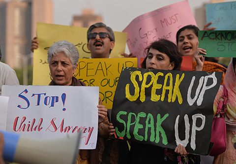 Pakistani rights activists carry placards as they shout slogans during a protest against a child sex abuse scandal in Islamabad on August 10, 2015. Pakistani police on August 10 arrested five more people over a major child sex abuse scandal after a lawyer for the victims accused them of protecting the culprits and activists warned the case was just the tip of the iceberg. At least 280 children were filmed being sexually abused by a gang of 25 men who used the hundreds of videos they produced to blackmail the youngsters' parents, according to Latif Ahmed Sara, a lawyer and activist representing the victims. AFP PHOTO / Aamir QURESHI