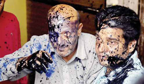 Jammu and Kashmir lawmaker Abdul Rashid Sheikh, (left) reacts after suspected activists of a right-wing organization threw ink on his face after he addressed a press conference yesterday. According to local reports Rashid had been protesting against the death of a Muslim teenager attacked by a Hindu mob over rumors of cows being slaughtered. — AFP