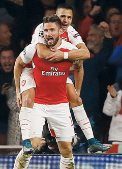 Arsenal’s Olivier Giroud (front) and Arsenal’s Alexis Sanchez celebrate after scoring during the Champions League Group F soccer match between Arsenal and Bayern Munich. — AP