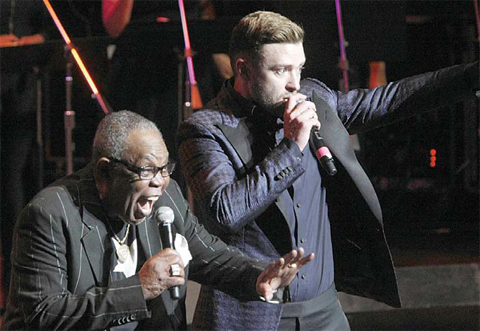 Sam Moore, left, and Justin Timberlake perform on stage.
