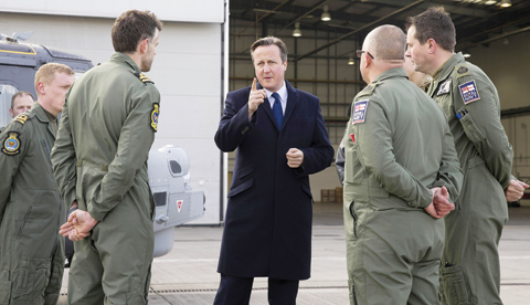 LONDON: British Prime Minister David Cameron, center, talks with Royal Navy personnel during his visit to Royal Air Force station RAF Northolt, in west London yesterday before presenting his government’s Strategic Defense and Security Review (SDSR) to Parliament.—AP