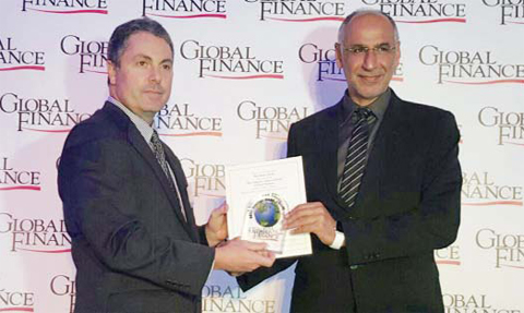 Dr Al-Hasawi receiving one of the awards from Global Finance representative