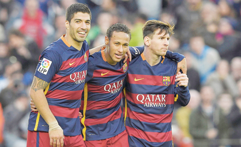 Barcelona’s Brazilian forward Neymar (center) celebrates with Barcelona’s Uruguayan forward Luis Suarez (left) and Barcelona’s Argentinean forward Lionel Messi after scoring their third goal. — AFP