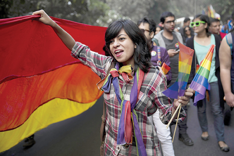NEW DELHI: A participant holds a rainbow flag during a gay pride parade in New Delhi yesterday. Hundreds of gay rights activists danced to drum beats and held colorful balloons as they marched celebrating what they call the diversity of gender and sexuality. —AP