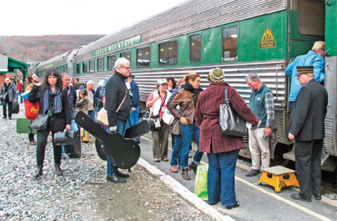 Travelers board the Roots on the Rails music train in Bellows Falls, Vt.