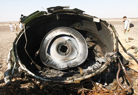 HASSANA: Egyptian Military experts examine a piece of an engine at the wreckage of a passenger jet bound for St Petersburg in Russia that crashed in Hassana, Egypt on Sunday, Nov 1, 2015. —AP