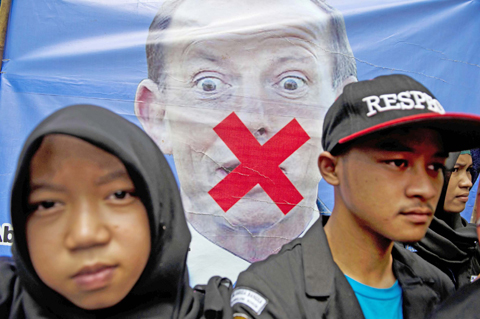 JAKARTA: In this file picture taken on March 10, 2015, Indonesian demonstrators rally in front of a vandalized portrait of Australian Prime Minister Tony Abbott during a protest outside the Australian Embassy. — AFP