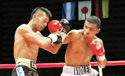TOKYO: Nicaraguan challenger Oliver Flores, right, send a left to Japanese champion Takashi Uchiyama in the first round of their WBA world super featherweight boxing title match in Tokyo, yesterday. Uchiyama defended his title with a technical knockout in the third round. – AP