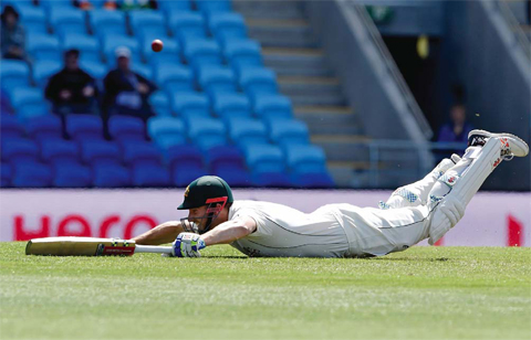 HOBART: Australia’s Shaun Marsh dives to avoid a run out against the West Indies during their cricket test match. — AP
