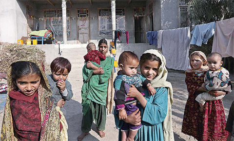 Internally displaced girls hold babies after their family left their village in Behsood district of Jalalabad east of Kabul, Afghanistan