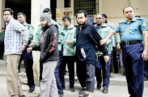 DHAKA: Bangladeshi policemen escort three of the eight people accused of killing an atheist blogger in 2013, to a court. — AP