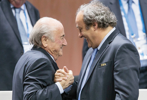 May 29, 2015 file photo, FIFA president Sepp Blatter is greeted by UEFA President Michel Platini, right, after Blatters re-election as president at the Hallenstadion in Zurich, Switzerland. Sepp Blatter and Michel Platini have been banned for 8 years, the FIFA ethics committee said yesterday.— AP