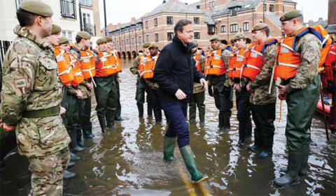 YORK: Britain’s Prime Minister David Cameron greets soldiers working on flood relief in York city centre after the river Ouse burst its banks. — AP