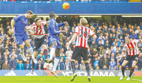 LONDON: Chelsea’s Branislav Ivanovic, left, scores his side’s first goal during the English Premier League soccer match between Chelsea and Sunderland at Stamford Bridge stadium in London, yesterday. — AP
