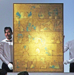 In this photograph, Indian abstract artist Vasudeo Gaitonde’s untitled painting is displayed as William Robinson, lead auctioneer (unseen) seeks bids during the third Christie’s India Sale at Taj Mahal Palace in Mumbai.—AFP