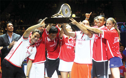 Singapore Slammers team members celebrate with the trophy after winning the International Premier Tennis League (IPTL) in Singapore