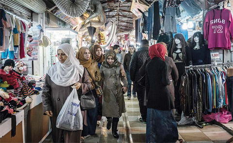 IRBIL: In this Thursday, Dec. 3, 2015, photo, women shop at Langa popular market, in Irbil, Iraq. Less than two years ago, Iraq’s northern Kurdish region was booming, as oil revenues poured in and foreign investors flocked to a rare island of stability in a turbulent region, but that all began to change when the black flags of the Islamic State group darkened the horizon. —AP