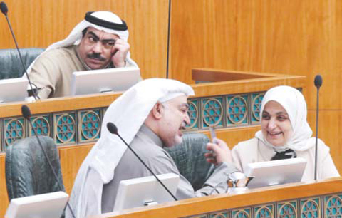 KUWAIT: Social Affairs and Labor and Planning Minister Hind Al-Subaih speaks to MP Khaleel Al-Saleh as MP Rawdan Al-Rawdan looks on during a parliament session at the Assembly yesterday. — Photo by Yasser Al-Zayyat