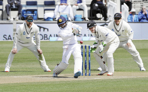 DUNEDIN: Sri Lanka’s Kusal Mendis bats in front of New Zealand’s BJ Watling, second from right, on day four of their first international cricket test at University Cricket Oval in Dunedin, New Zealand, yesterday. — AP