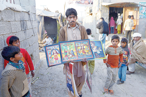 ISLAMABAD: A Pakistani vendor sells Christmas placards on the outskirts of Islamabad. —AFP