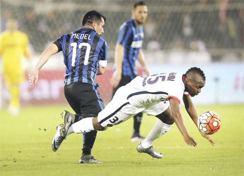 DOHA: Paris Saint-Germain (PSG)’s Congolese forward Hervin Ongenda falls as he fights for the ball against Inter Milan’s Chilean midfielder Gary Medel during the friendly football match between PSG and Inter Milan at Jassim Bin Hamad Stadium in the Qatari capital Doha, yesterday. — AFP