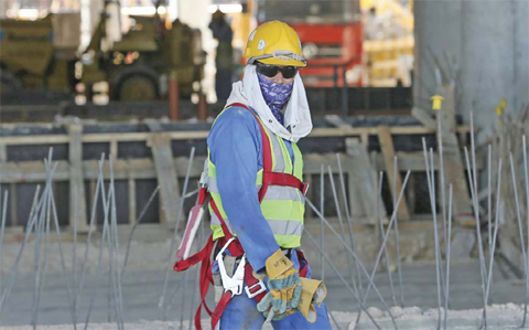 DOHA: A migrant laborer walks as he works on a construction site in Doha. Qatar has done ‘almost nothing’ to end labor abuse in the five years since being awarded football’s 2022 World Cup despite huge global pressure to reform, Amnesty International said yesterday. — AFP