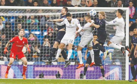 MADRID: Real Madrid’s Cristiano Ronaldo, right, jumps for the ball next to other players, during a Champions League group A soccer match between Real Madrid and Malmo at the Santiago Bernabeu stadium in Madrid. — AP