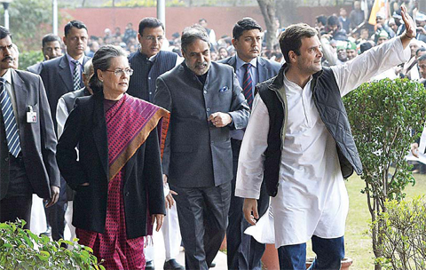 Vice-President of India’s Congress Party Rahul Gandhi (right) waves as he walks with his mother and party President Sonia Gandhi towards a media briefing inside All India Congress Committee (AICC) headquarters in New Delhi yesterday