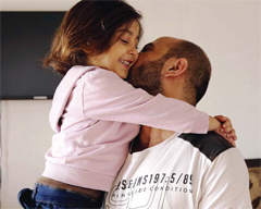 BEIRUT: Abdul Halim al-Attar, kisses his daughter Reem, 4, at their house, in Beirut, Lebanon. Al-Attar, a refugee from Syria who was photographed selling pens in the streets of Beirut, is now running three businesses in the city after an online crowdfunding campaign in his name collected $191,000. —AP